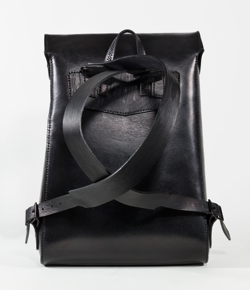 “Black VELA backpack showing the adjustable shoulder straps and rear view.”