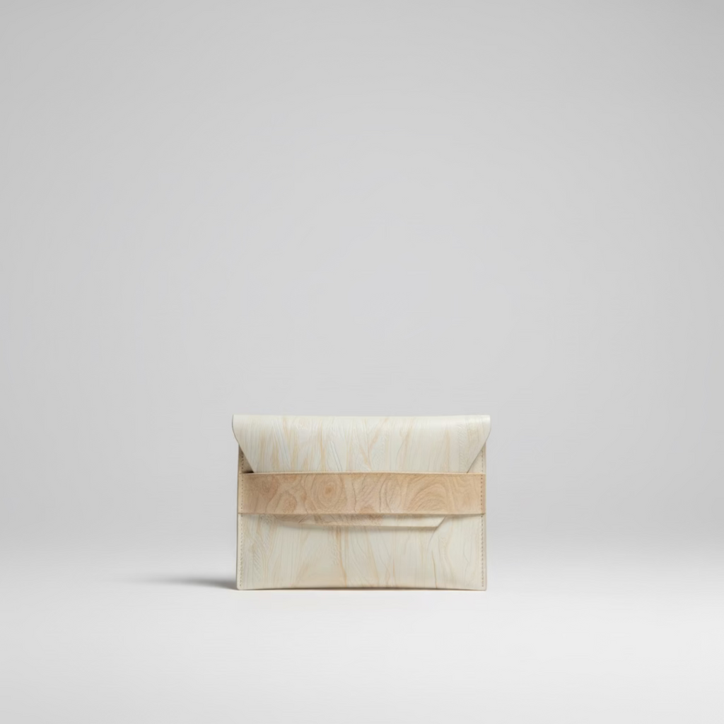 “Élan No. 03 Nude Grain leather envelope clutch, front view.”
