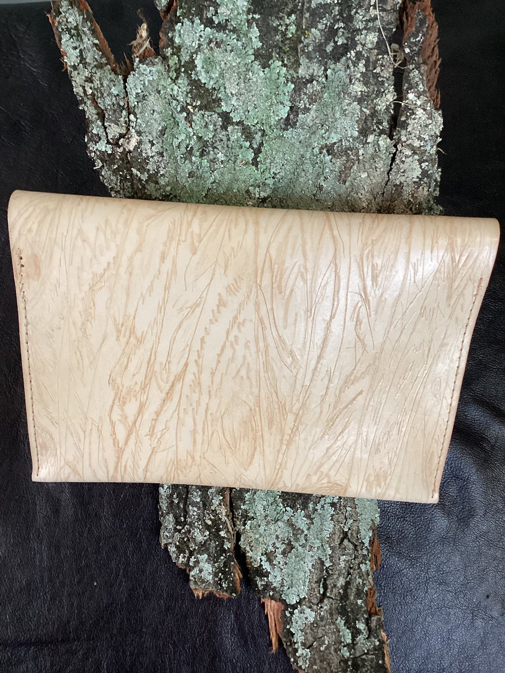 “Nude Grain leather envelope clutch, back construction detail.”