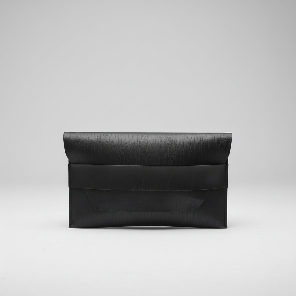 “Black Élan No. 01 Noir leather envelope clutch, front view.”
