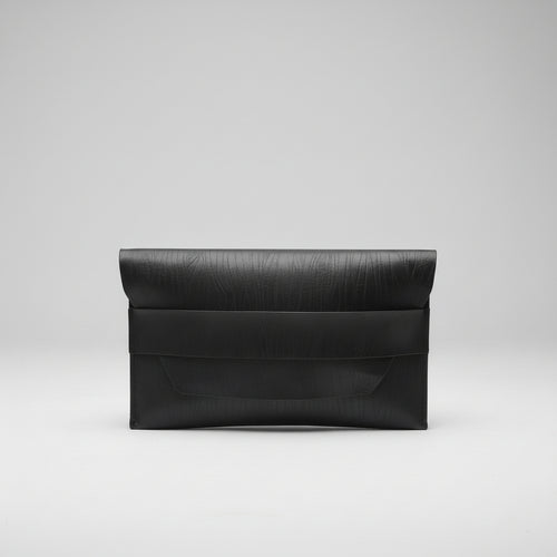 “Black Élan No. 01 Noir leather envelope clutch, front view.”
