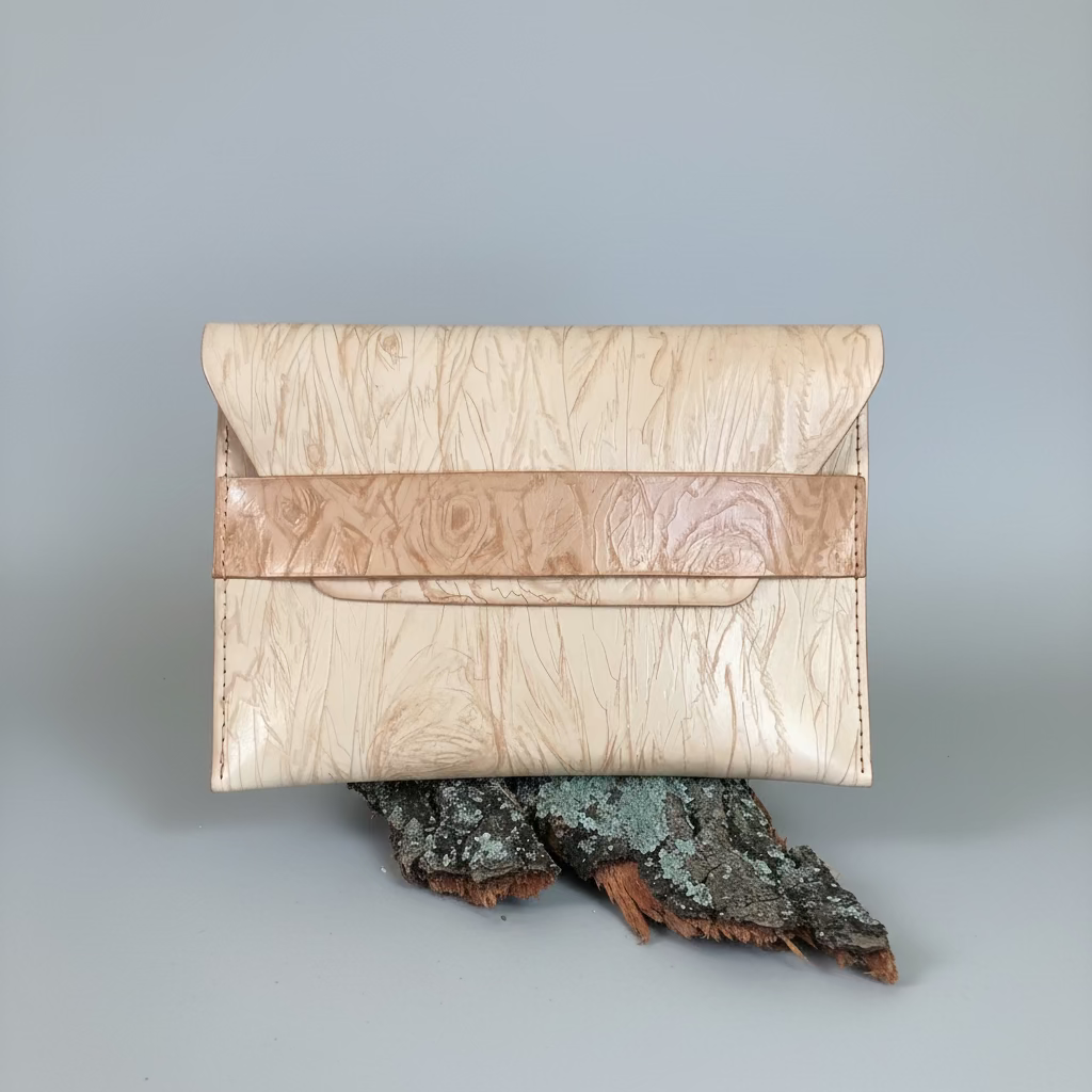 “Natural nude leather envelope clutch showing the grain texture.”